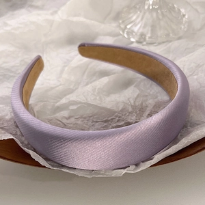 Detailed view of lavender padded satin headband with silk texture and non-slip inner lining