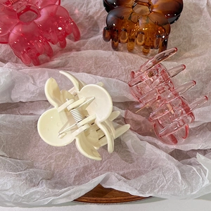 Floral hair claws in four colors on soft tissue paper for elegant women hair styling