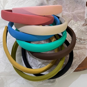 Close-up of colorful thick sponge headbands stacked showing fine fabric texture
