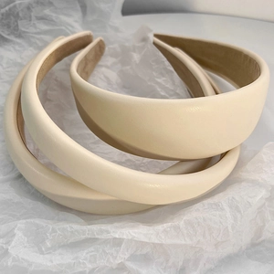 Three minimalist beige faux leather padded headbands with soft non-slip velvet lining