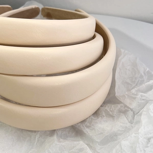 Detailed view of cream PU leather sponge headbands with soft non-slip velvet lining