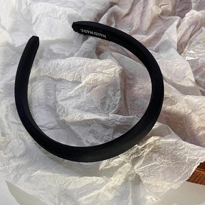 Detail shot of the inner white HANDMADE silk print on a thick black padded sponge headband