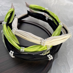 Elegant pleated satin headbands set with pearl accents in black, green, and beige colors