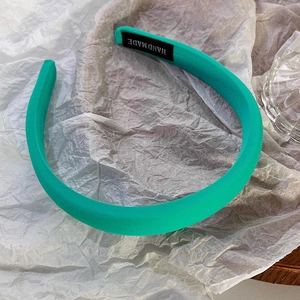 Detail showing the handmade label and ribbed mint green fabric on thick headband