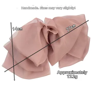 Detail of a large 27cm pink-purple organza bow hair clip with lightweight fabric layers