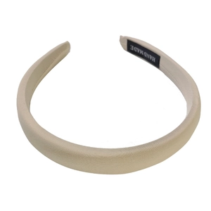 Minimalist beige handmade hair hoop with smooth fabric texture on white background