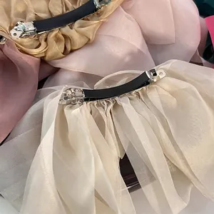 Oversized chiffon organza layered bow hair clips in champagne gold and lotus pink colors