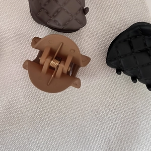Matte grid hair claws in black and brown colors with quilted texture for women
