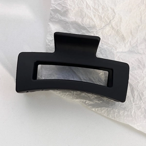 Detail view of the elegant matte black rectangular hollow hair claw clip for women