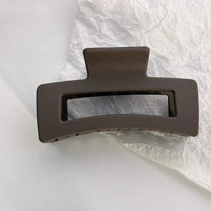 Macro detail of a large matte chocolate brown rectangular hollow hair claw clip
