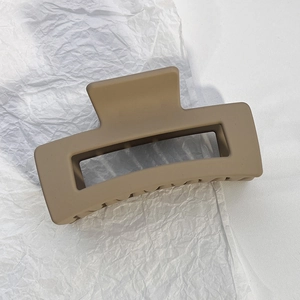 Macro detail of the matte khaki rectangle hollow hair claw clip with strong teeth