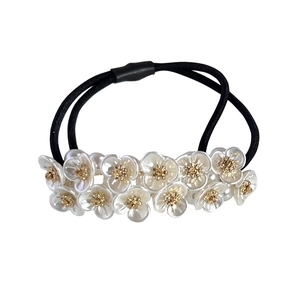 Elegant white pearl flower hair scrunchie with gold center details on black elastic band