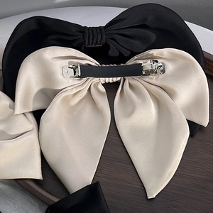 Elegant large satin bow hair clips in black and champagne beige with metal spring clips