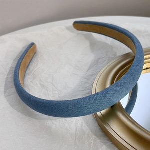 Macro detail of blue denim headband with soft beige suede inner lining texture