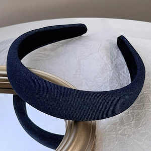 Detailed close-up showing the fine texture of blue denim fabric on a wide sponge headband