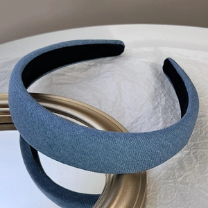 Close-up of blue denim padded headband showing fabric texture and black anti-slip lining