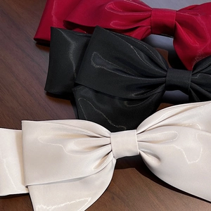 Elegant large satin bow hair clips in red, black, and beige for retro French hairstyles