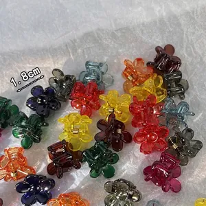 Set of 1.8cm mini flower-shaped acrylic hair claw clips in assorted vibrant colors