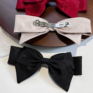 Three elegant French style satin bow hair clips in burgundy, beige and black