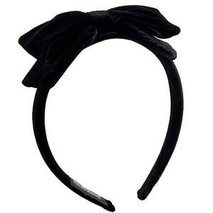 Elegant black velvet bow headband with handmade label on a clean white background