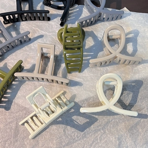 Selection of minimalist plastic hair claws in various colors and matte finishes
