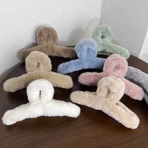 Macro shot showing 8 assorted colors of plush faux fur hair claw clips for winter