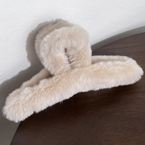 Detailed close-up showing soft plush texture of the cream-colored large shark hair clip