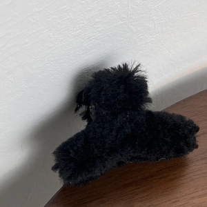 Close-up of elegant black plush hair claw clip for autumn winter hair styling