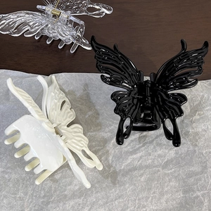 Elegant black and white butterfly hair claws in glossy resin for French twist hairstyles