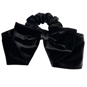Elegant black velvet bow hair scrunchie with a large vintage ribbon design on white background