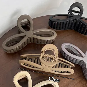 Matte finish large bow-shaped hair claw clips in various earth tones for thick hair