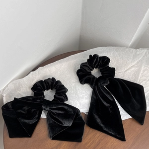 Detail of premium black velvet bow scrunchie and long ribbon hair tie set for women