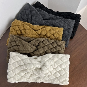 Detailed close-up showing textured diamond knit pattern and twist design of woolen headbands