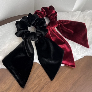 Detailed view of high-quality black and burgundy velvet bow hair ties with ribbons