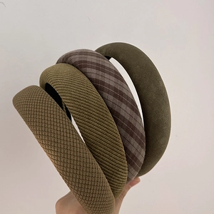 Detail showing four vintage green and plaid fabric headbands with thick sponge padding