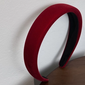 Close-up detail of burgundy velvet wide headband with premium plush texture and black inner lining