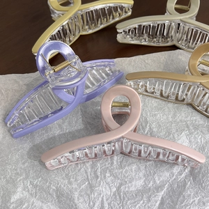 Macro shot of large shark hair clips in pastel colors with matte finish and metal spring