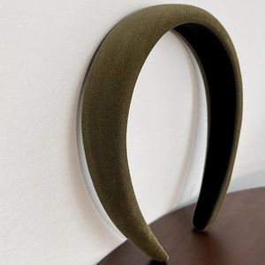 Detail view of the thick olive green velvet padded headband with a non-slip black inner lining