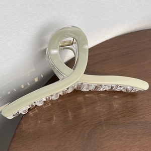 Detail view of large matte green hair claw clip with strong metal spring for thick hair