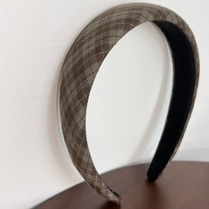 Detail of vintage brown plaid fabric headband with non-slip lining for women