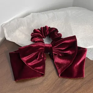Elegant red velvet bow hair tie scrunchie in vintage Hepburn style for women
