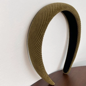 Close-up of olive green ribbed fabric texture on a padded retro style headband