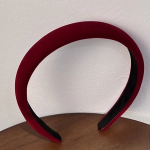 Detail of burgundy velvet padded headband with non-slip lining and thick French retro design