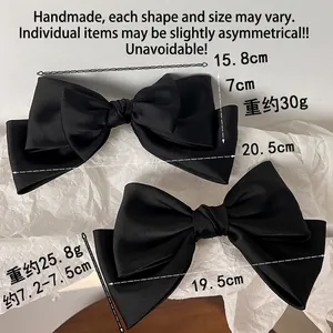 Elegant black satin bow hair clips in two sizes with dimensions and handcrafted details