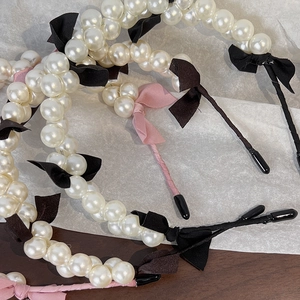Detail of elegant pearl headband with fabric bows and comfortable anti-slip tips