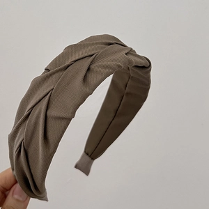 Macro view of dark coffee corduroy twisted headband showing ribbed fabric texture