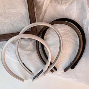 Detail of satin handmade headbands in silver grey, dark brown, and black colors