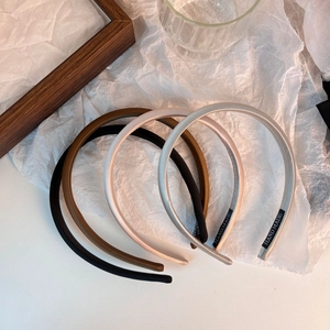 Close-up of handmade satin headbands with fine texture and high-density silk luster