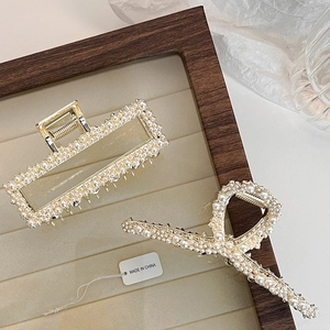 Elegant gold alloy hair claws with white pearls in rectangular and infinity shapes