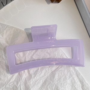 Detail of light purple rectangular hair claw clip with glossy finish and strong metal spring